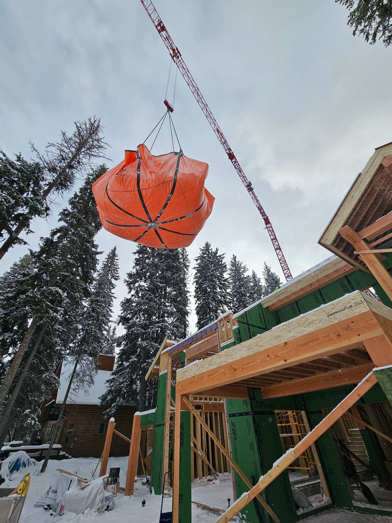 Using a crane and an Outpak debris tarp to remove snow.
