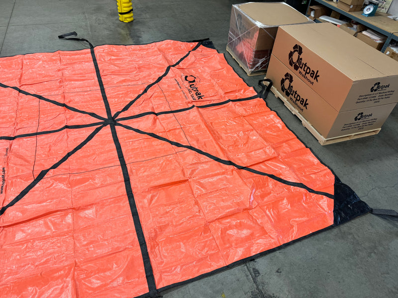 An Outpak sling tarp layed out on the floor for size.