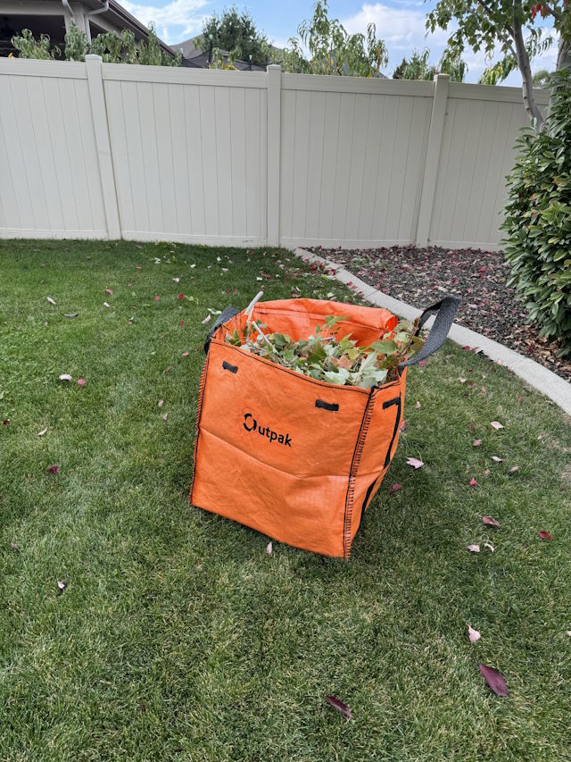 Outpak Debris Bag Mini in the yard.