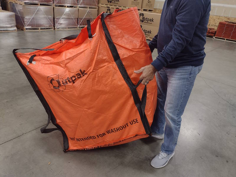 Pulling an Outpak Debris Bag by Hand in a warehouse