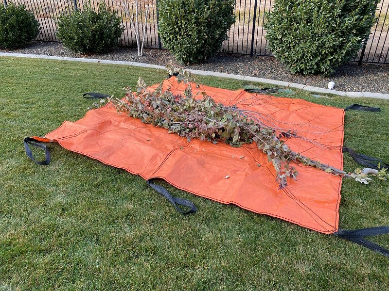 Outpak sling tarp with yard debris.